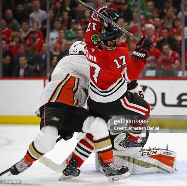 Lance Bouma of the Chicago Blackhawks is sent to the ice by Cam Fowler of the Anaheim Ducks in front of John Gibson at the United Center on February...