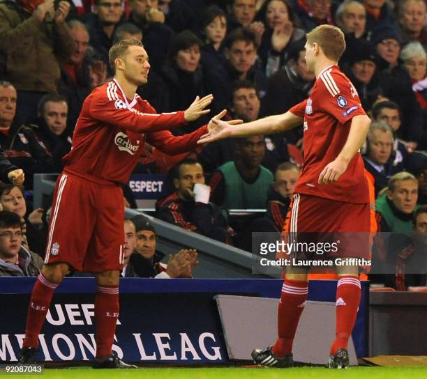 Steven Gerrard of Liverpool is consoled by Fabio Aurelio as he leaves the pith injured during the UEFA Champions League Group E match between...