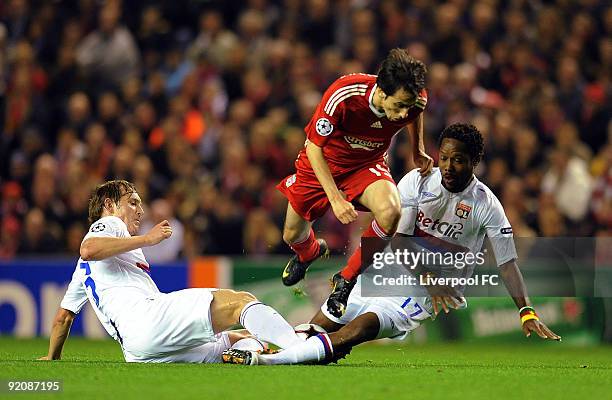 Yossi Benayoun of Liverpool steams past Kim Kallstrom and Jean Il Makoun during the UEFA Champions League group E match between Lyon and Liverpool at...