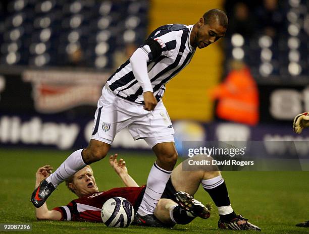 Alan Tate of Swansea City tackles Luke Moore to the ball during the Coca- Cola Championship match between West Bromwich Albion and Swansea at the...