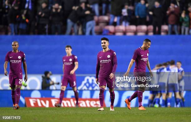 Ilkay Gundogan of Manchester City and his teammates look dejected after Wigan Athletic score their first goal during the Emirates FA Cup Fifth Round...