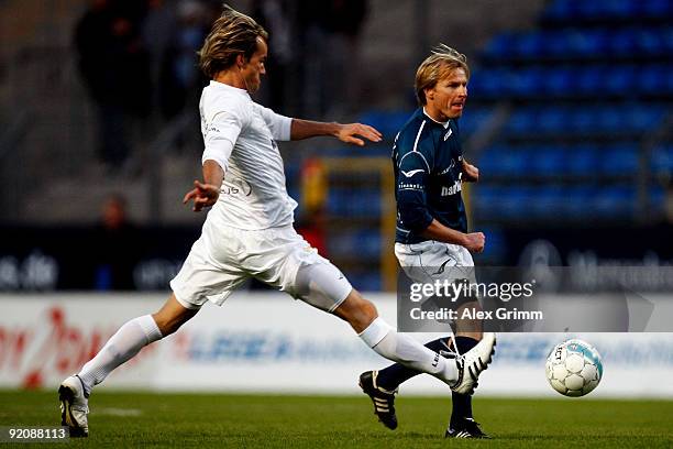 Lothar Sippel is challenged by Sven Hannawald during the charity football match "Klitschko meets Becker" at the Carl-Benz stadium on October 20, 2009...