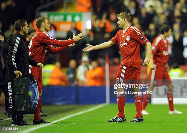 An injured Steven Gerrard of Liverpool walks off for Fabio Aurelio of Liverpool during the UEFA Champions League group E match between Lyon and...