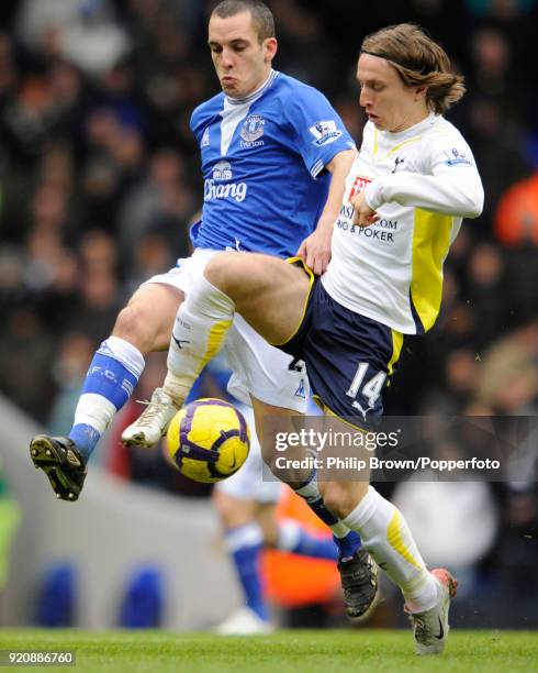 Luka Modric of Tottenham clashes with Leon Osman of Everton during the Barclays Premier League match between Tottenham Hotspur and Everton at White...