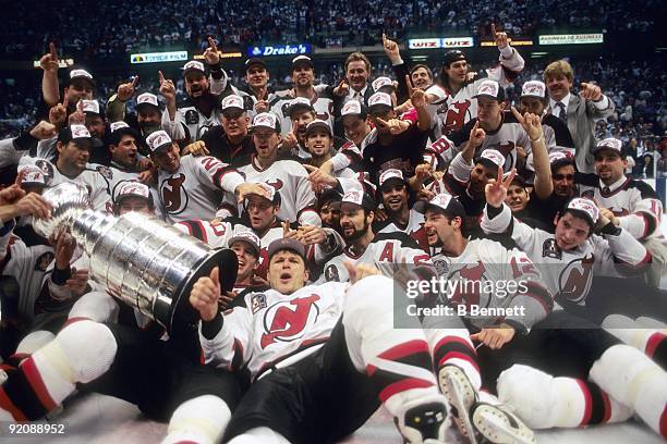 Members of the 1994-95 New Jersey Devils team pose for a group photo with the Stanley Cup after defeating the Detroit Red Wings in Game 4 of the 1995...