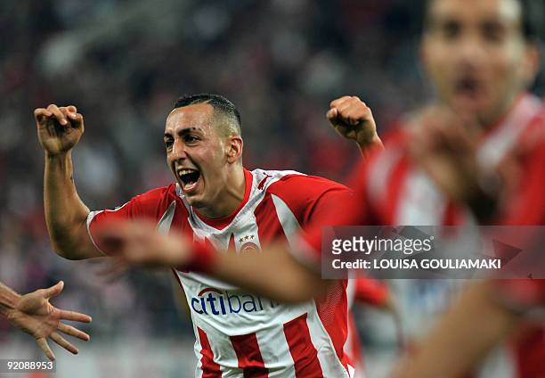 Olympiacos Piraeus Kostas Mitroglou and players celebrate their goals against Standard Liege during their UEFA Champions League match at the...