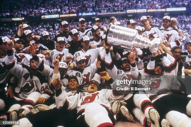 Members of the 1994-95 New Jersey Devils team pose for a group photo with the Stanley Cup after defeating the Detroit Red Wings in Game 4 of the 1995...
