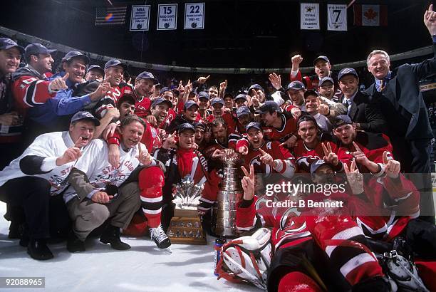 Members of the 1999-2000 New Jersey Devils team pose for a group photo with the Stanley Cup after defeating the Dallas Stars in Game 6 of the 2000...