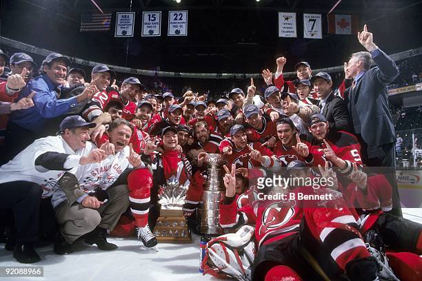 Members of the 1999-2000 New Jersey Devils team pose for a group photo with the Stanley Cup after defeating the Dallas Stars in Game 6 of the 2000...