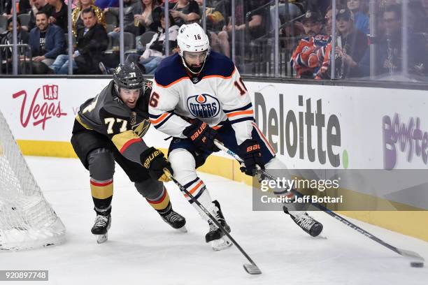 Jujhar Khaira of the Edmonton Oilers handles the puck near the boards with Brad Hunt of the Vegas Golden Knights defending during the game at...