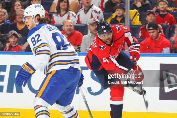 Devante Smith-Pelly of the Washington Capitals shoots the puck as Nathan Beaulieu of the Buffalo Sabres watches the play during an NHL game on...