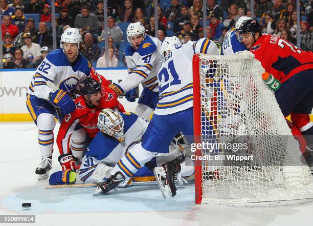 Kyle Okposo of the Buffalo Sabres tries to defend the net as Chad Johnson, Nathan Beaulieu and Justin Falk are tied up with Jakub Vrana of the...