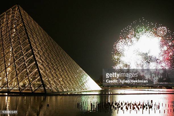 Fire work is shot in front of the Louvre Pyramid for the launch of the Fiac, contemporary art fair of Paris, at Cour Carree du Louvre on October 20,...