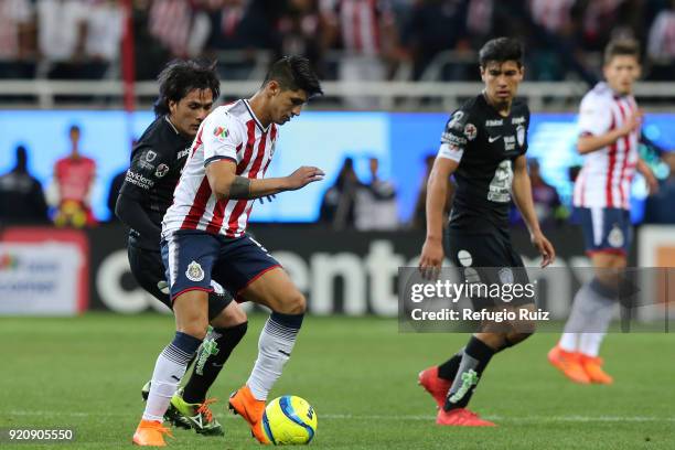 Alan Pulido of Chivas fights for the ball with Jorge Hernandez of Pachuca during the 8th round match between Chivas and Pachuca as part of the Torneo...