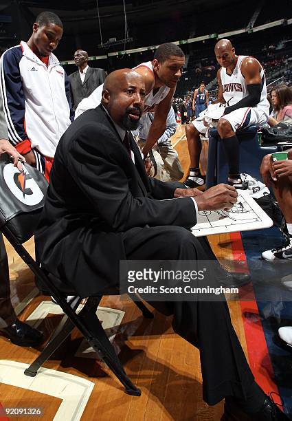 Head coach Mike Woodson of the Atlanta Hawks instructs his team during a timeout in the preseason game against the Washington Wizards on October 19,...
