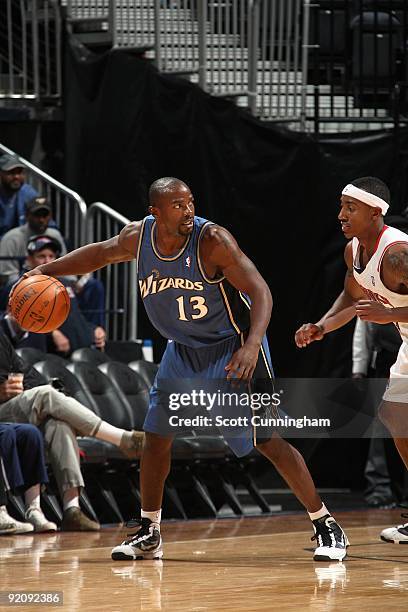 Mike James of the Washington Wizards handles the ball against Jeff Teague of the Atlanta Hawks during the preseason game on October 19, 2009 at...