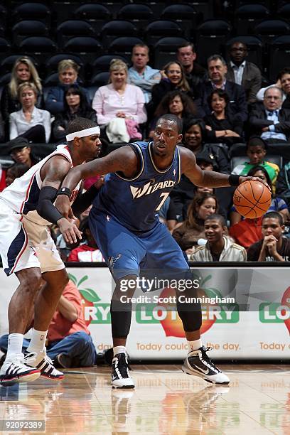 Andray Blatche of the Washington Wizards posts up against Josh Smith of the Atlanta Hawks during the preseason game on October 19, 2009 at Philips...