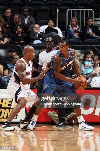 Caron Butler of the Washington Wizards handles the ball against Maurice Evans of the Atlanta Hawks during the preseason game on October 19, 2009 at...
