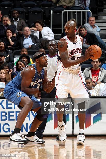 Joe Smith of the Atlanta Hawks looks to maneuver against Brendan Haywood of the Washington Wizards during the preseason game on October 19, 2009 at...