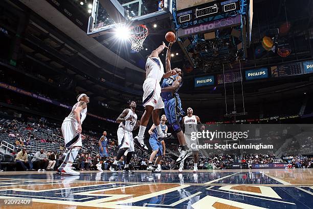 Brendan Haywood of the Washington Wizards goes to the basket under pressure against Al Horford of the Atlanta Hawks during the preseason game on...