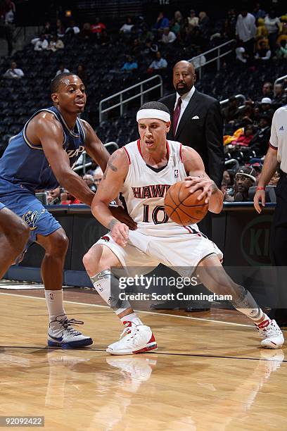 Mike Bibby of the Atlanta Hawks handles the ball against Randy Foye of the Washington Wizards during the preseason game on October 19, 2009 at...