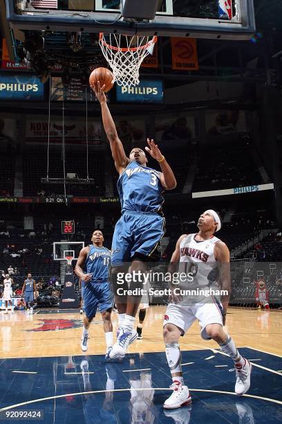 Caron Butler of the Washington Wizards goes to the basket against Mike Bibby of the Atlanta Hawks during the preseason game on October 19, 2009 at...