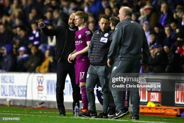 Manchester City manager Josep Guardiola talks with Kevin De Bruyne of Manchester City before making a substitution during the Emirates FA Cup Fifth...