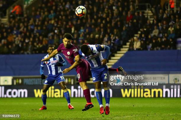 Sergio Aguero of Manchester City is challenged by Nathan Byrne of Wigan Athletic as he heads the ball during the Emirates FA Cup Fifth Round match...