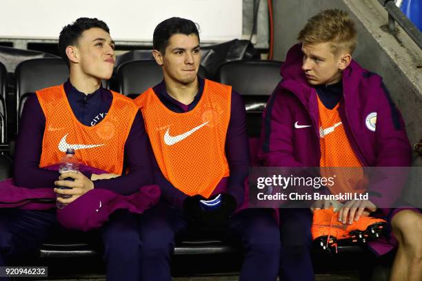 Alexander Zinchenko, Phil Foden and Brahim Diaz all of Manchester City watch the action from the substitutes bench during the Emirates FA Cup Fifth...