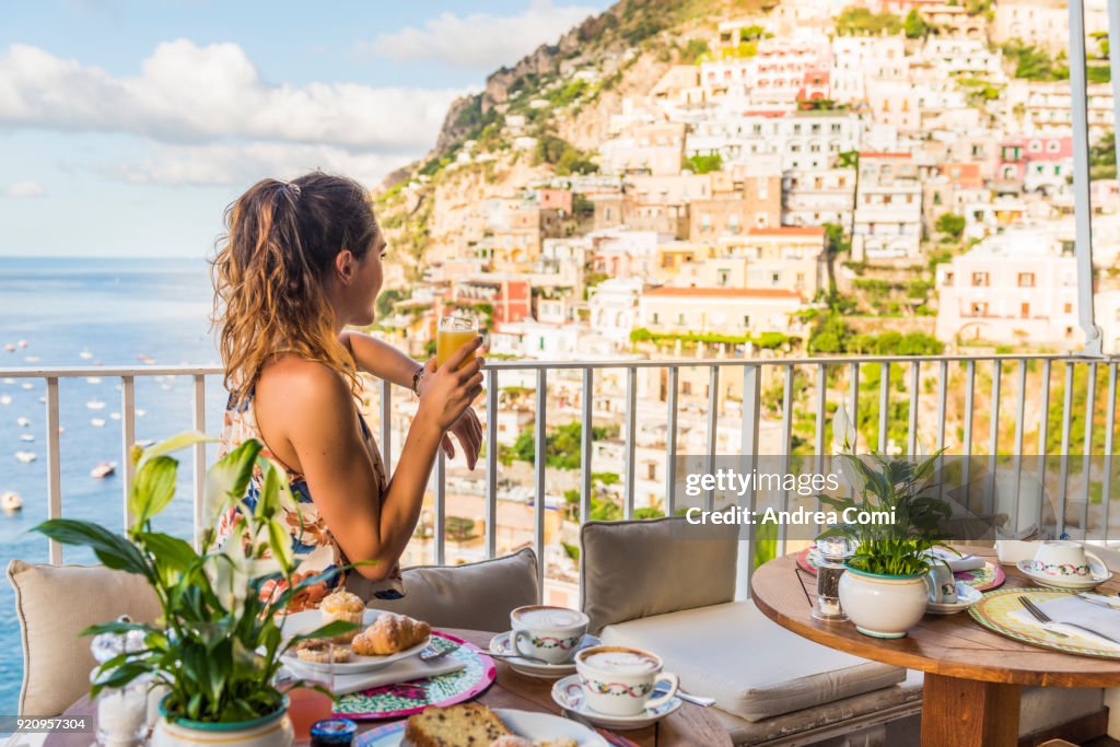 Young woman having breakfast in Positano
