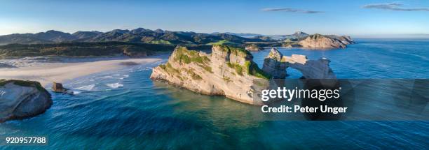 archway islands at wharariki beach,cape farewell, tasman, new zealand - nelson new zealand fotografías e imágenes de stock