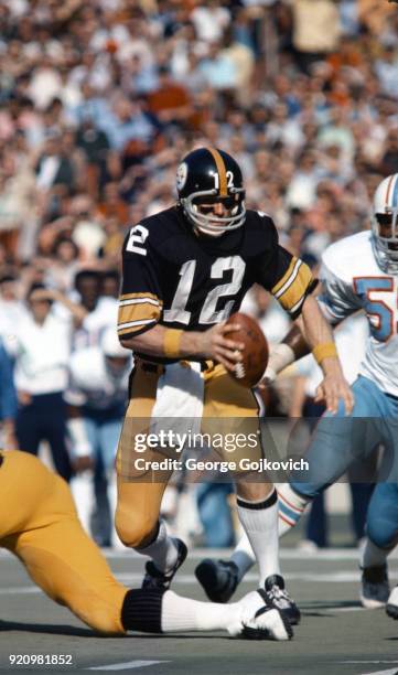 Quarterback Terry Bradshaw of the Pittsburgh Steelers runs with the football during a game against the Houston Oilers at Three Rivers Stadium on...