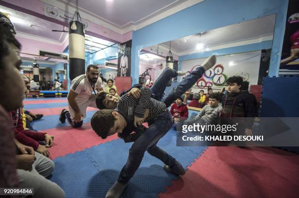 Syrian refugee Amir al-Awad , the cofounder of the Syrian Sports Academy, watches as students train at the academy in Egypt's second city of...