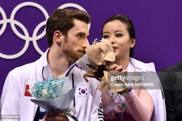 South Korea's Yura Min and South Korea's Alexander Gamelin react after competing in the ice dance free dance of the figure skating event during the...