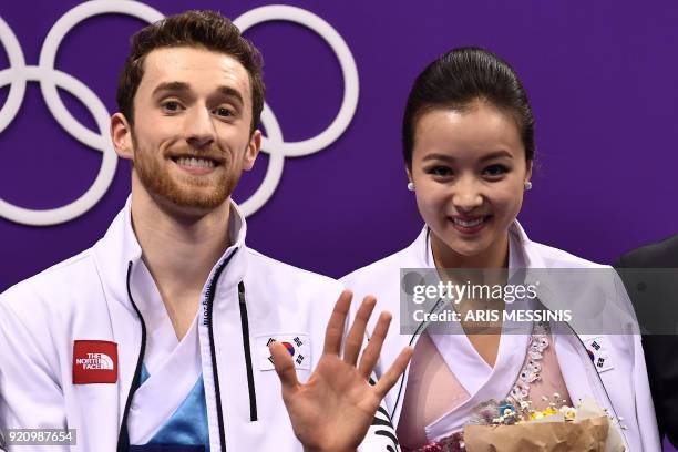 South Korea's Yura Min and South Korea's Alexander Gamelin react after competing in the ice dance free dance of the figure skating event during the...