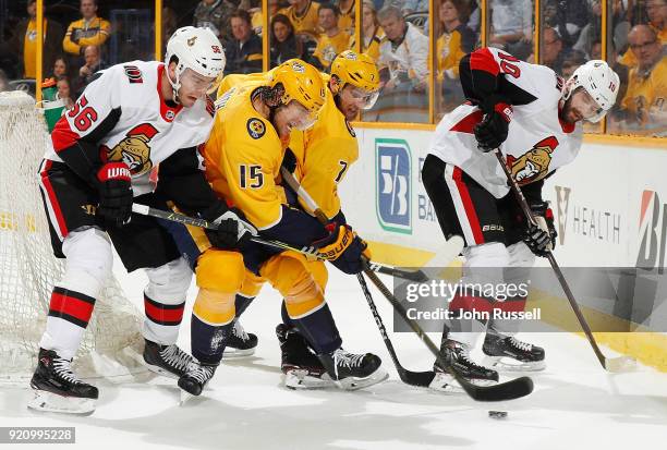 Craig Smith and Yannick Weber of the Nashville Predators battle against Magnus Paajarvi and Tom Pyatt of the Ottawa Senators during an NHL game at...