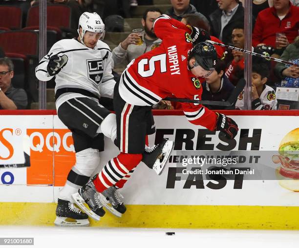 Dustin Brown of the Los Angeles Kings and Connor Murphy of the Chicago Blackhawks battle for the puck along the boards at the United Center on...