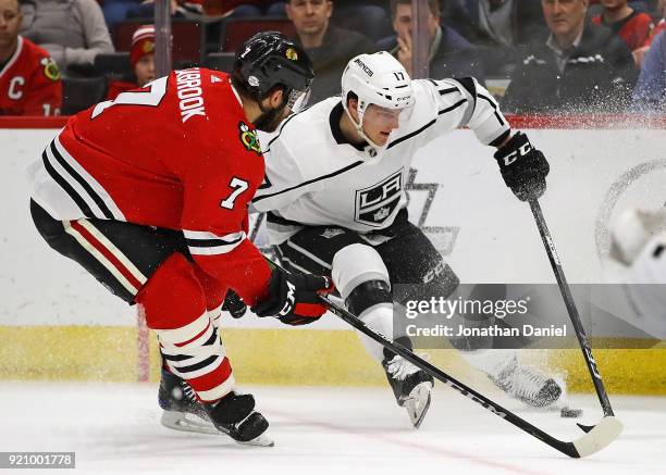 Torrey Mitchell of the Los Angeles Kings stops with the puck under pressure from Brent Seabrook of the Chicago Blackhawks at the United Center on...