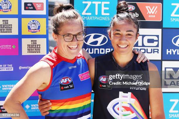 Carlton AFLW forward Darcy Vescio and Bulldog Emma Kearney pose in front of the E.J Whittem Stand with their Pride guernseys for Friday nightÕs game...