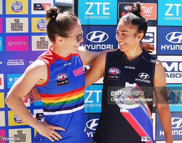 Carlton AFLW forward Darcy Vescio and Bulldog Emma Kearney pose in front of the E.J Whittem Stand with their Pride guernseys for Friday nightÕs game...