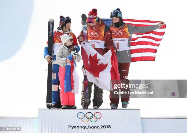 Marie Martinod of France, her daughter Melirose, Cassie Sharpe of Canada and Brita Sigourney stand on the podium after the Women's Halfpipe final at...