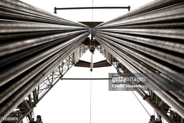 drilling rig with fully loaded drill pipes - borehole stock pictures, royalty-free photos & images