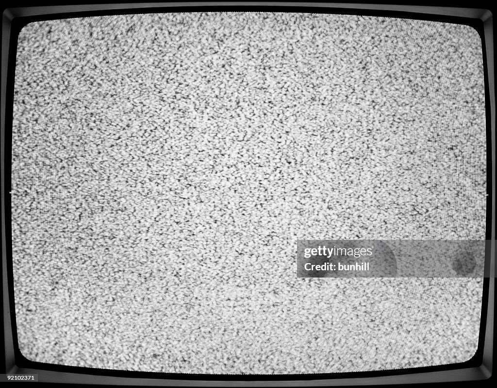 A close-up of a white noise on a TV screen