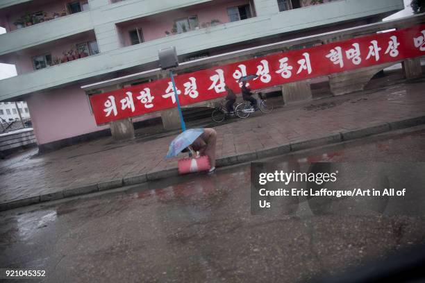 North Korean woman bending over in the street, South Hamgyong Province, Hamhung, North Korea on September 15, 2011 in Hamhung, North Korea.