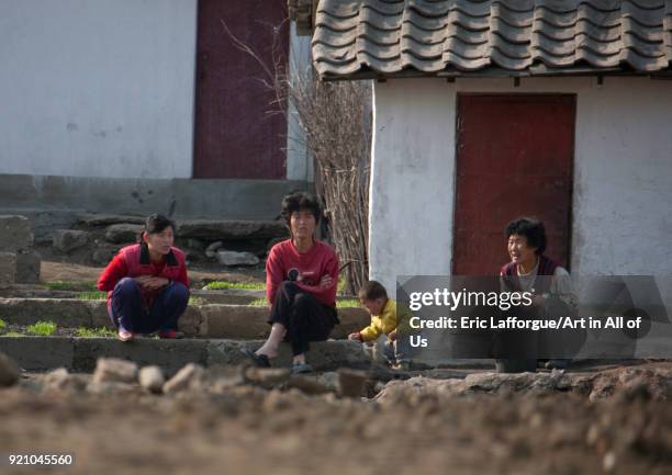 North Korean people sit in front of their house, Pyongan Province, Pyongyang, North Korea on May 2, 2010 in Pyongyang, North Korea.