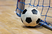 Football futsal ball, goal with net and floor. Indoor soccer sports hall. Sport Futsal background. Indoor Soccer Winter League