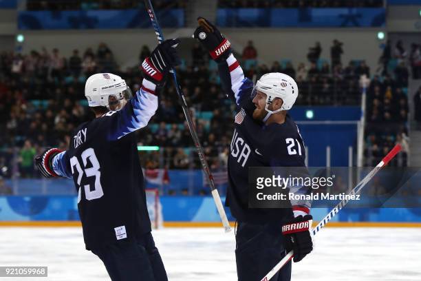 James Wisniewski of the United States celebrates after with his teammate Troy Terry after scoring a goal against Jan Laco of Slovakia in the second...