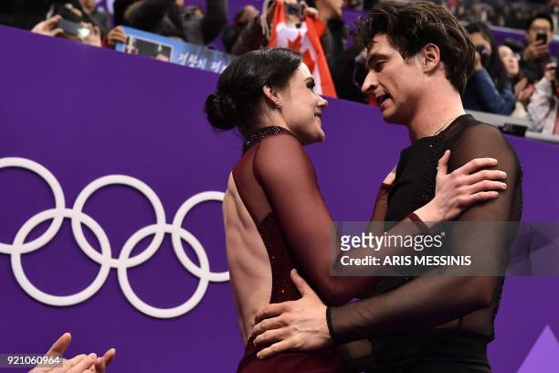 Canada's Tessa Virtue and Canada's Scott Moir celebrate their gold win in the ice dance free dance of the figure skating event during the Pyeongchang...