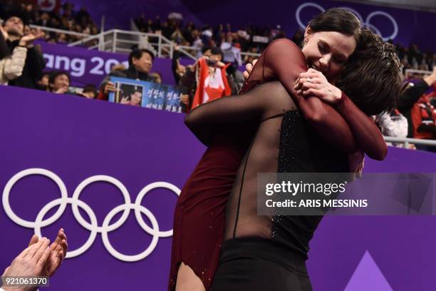 Canada's Tessa Virtue and Canada's Scott Moir celebrate their gold in the ice dance free dance of the figure skating event during the Pyeongchang...