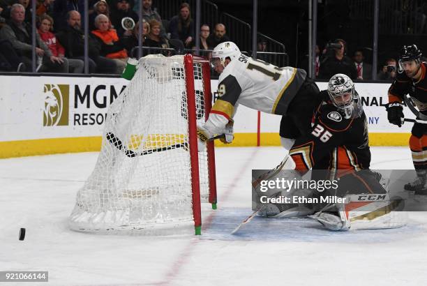 Reilly Smith of the Vegas Golden Knights knocks the goal loose as he trips over John Gibson of the Anaheim Ducks while trying to deflect the puck...